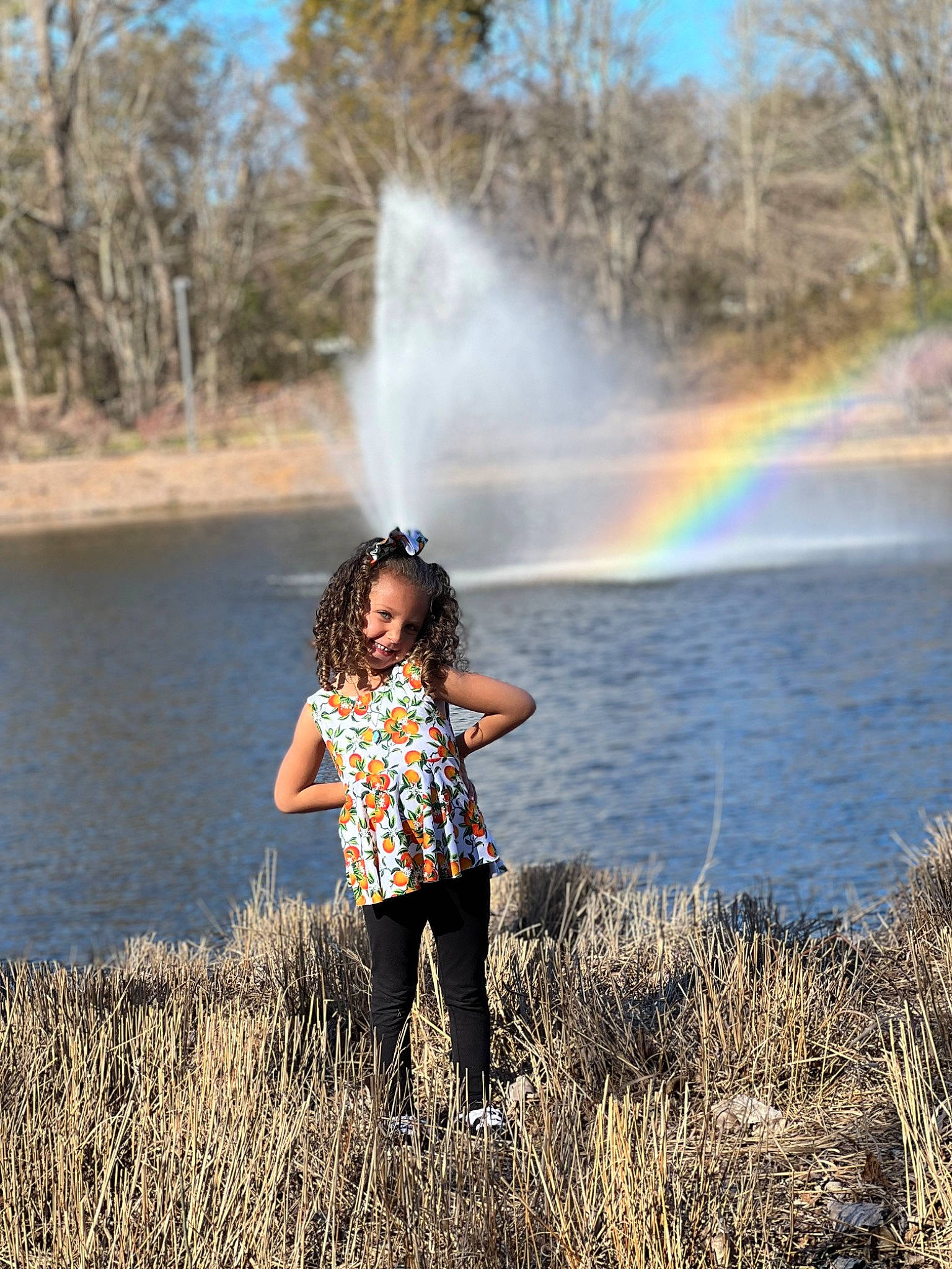 Braylee joined the competition — help win amazing prizes! bank, fun, grass, happy, lake, landscape, leisure, morning, natural_landscape, people_in_nature, person, plant, rainbow, recreation, reflection, sky, sunlight, travel, tree, water