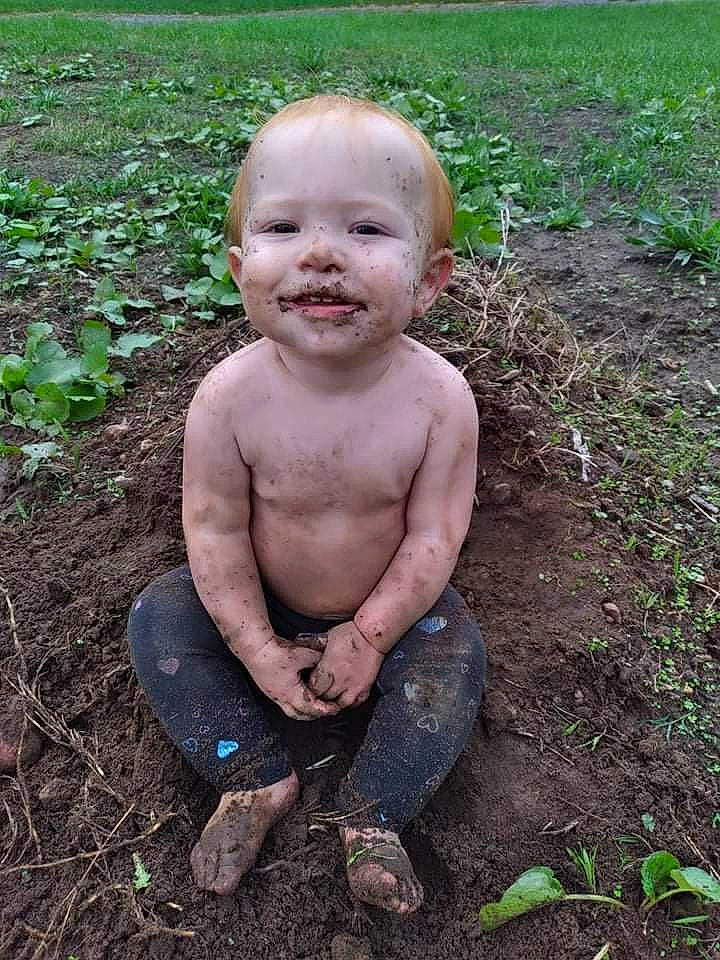 Blakelynn is registered to the contest to win money with this photo: baby, barechested, chest, child, foot, fun, garden, gardening, grass, grass_family, groundcover, happy, joy, leg, people_in_nature, person, plant, sitting, smile, soil