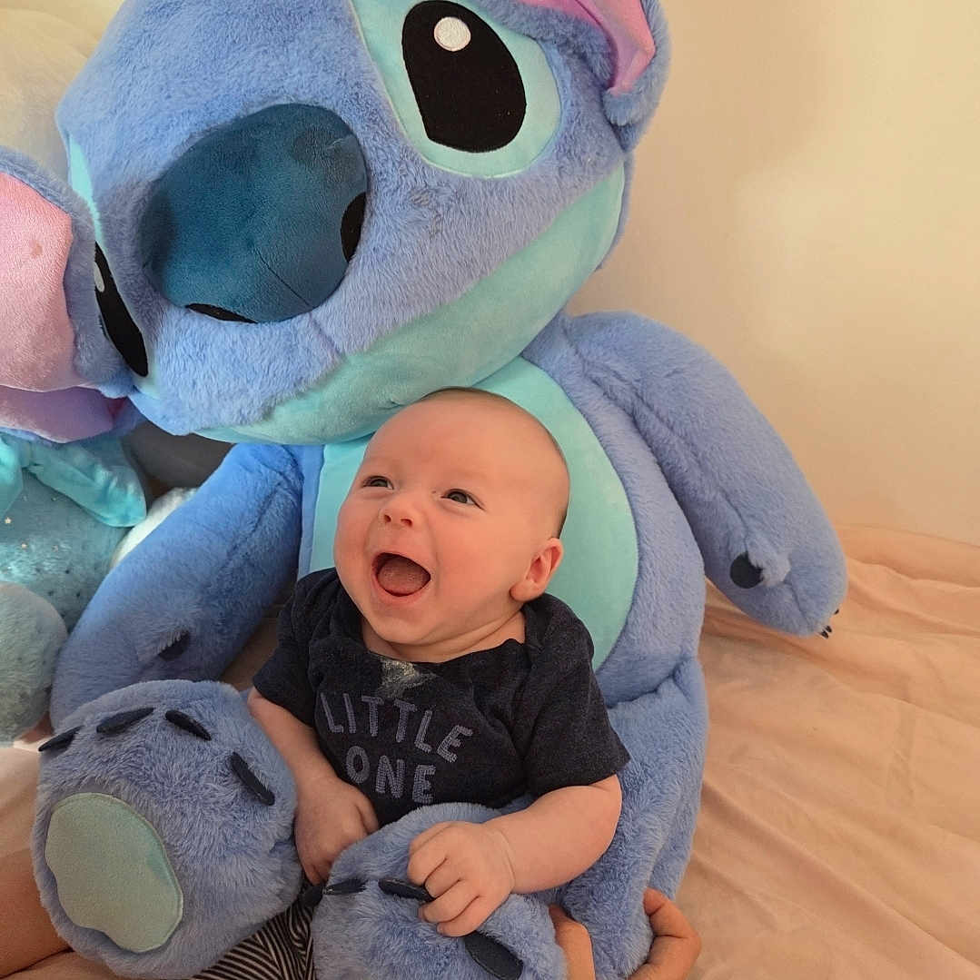 Averi joined the competition — help win amazing prizes! baby, bed, bedroom, blanket, couch, cushion, face, furniture, happy, head, homedecor, indoors, laughing, newborn, person, photography, plush, portrait, room, toy