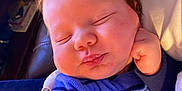 Bowen is registered to the contest to win money with this photo: baby, sleeping, infant, face, hair, hand, clothing, blue, striped, cute, peaceful, child, person, closeup, indoor, soft, fuzzy, skin, resting, portrait