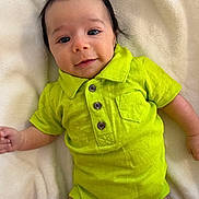 Youssef participe au concours pour gagner de l'argent avec cette photo : baby, infant, child, onesie, green_clothing, smile, face, eyes, hair, blanket, soft_texture, lying_down, hand, cute, portrait, skin, young_child, happy, indoor, closeup