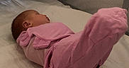 Elara is registered to the contest to win money with this photo: baby, infant, child, sleeping, pink_clothing, lying_down, raised_legs, mattress, crib, bedding, blanket, bedroom, indoor, portrait, face, profile, baby_suit, soft_lighting, home, photography