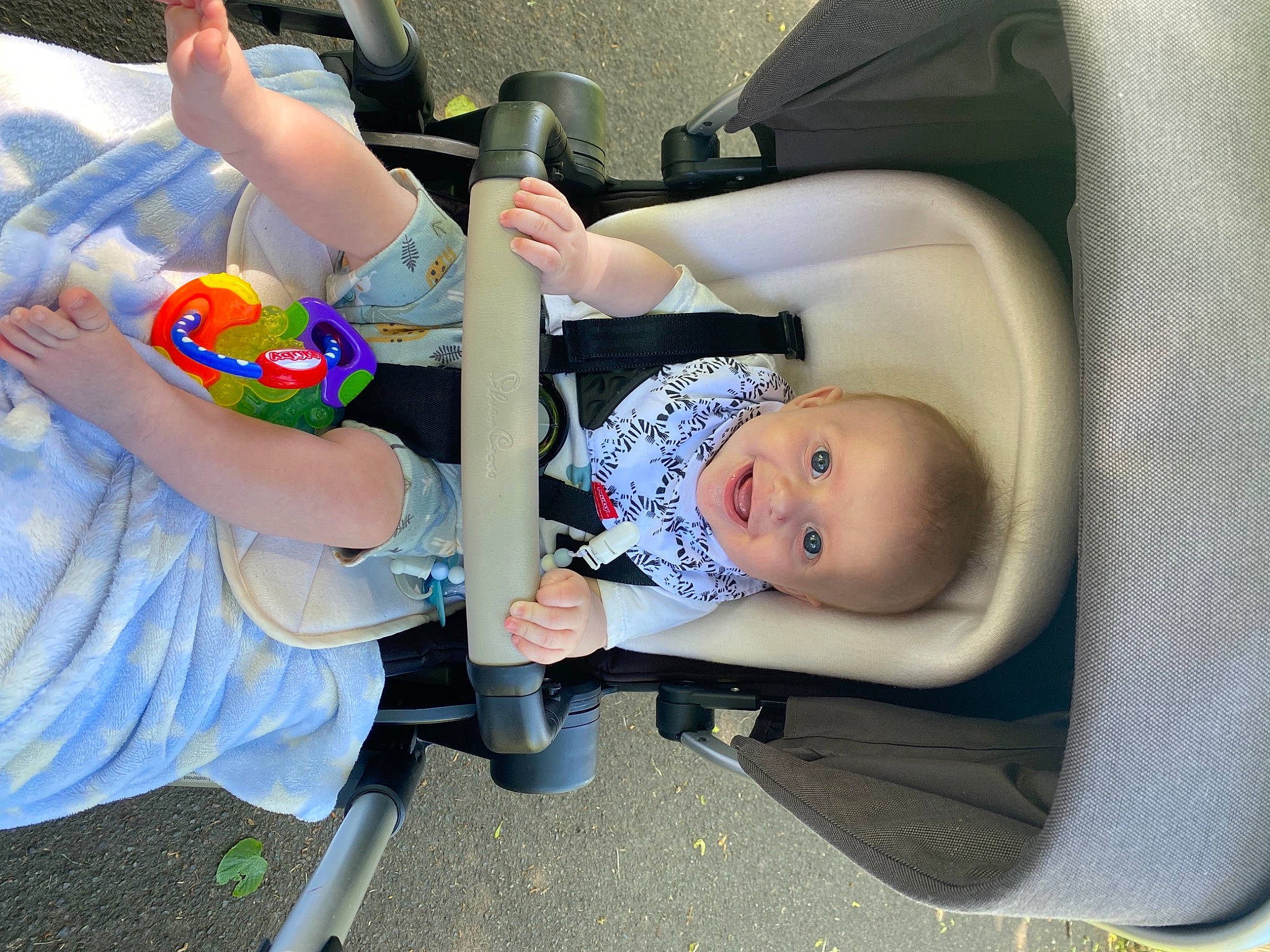 Charlie is registered to the contest to win money with this photo: arm, auto_part, baby, baby_carriage, baby_in_car_seat, baby_products, baby_toddler_clothing, car_seat, chair, child, comfort, elbow, fun, gesture, hand, human_leg, person, seat_belt, sitting, toddler