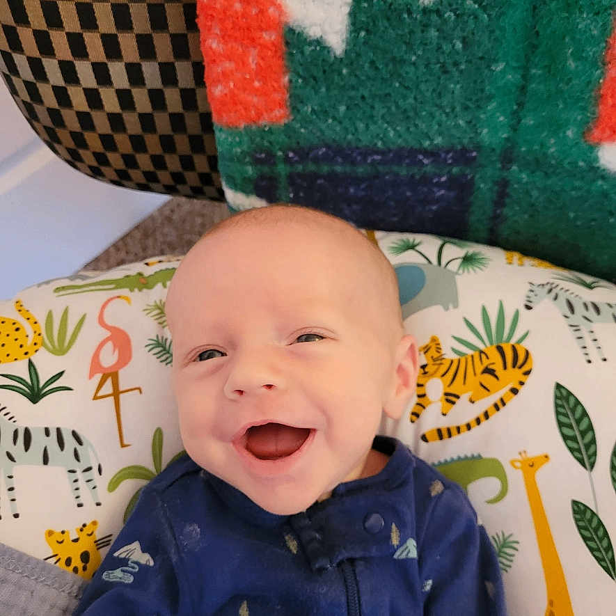 Grayson joined the competition — help win amazing prizes! baby, babylaughing, bodypart, clothing, couch, cushion, face, furniture, happy, hat, head, homedecor, laughing, mouth, newborn, pants, person, photography, portrait, smile