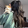 Willow Rose joined the competition — help win amazing prizes! back_view, calico_cat, casual_clothing, cat, companion, curious_cat, green_shirt, holding, home, indoor, light_fixture, long_hair, natural_light, person, pet, room, shoulder, television, white_pants, wooden_furniture