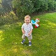 Jack is registered to the contest to win money with this photo: backyard, boy, clothing, face, footwear, grass, green, head, nature, outdoors, pants, park, person, photography, plant, portrait, shoe, tree, vegetation, yard