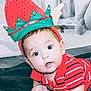 baby, infant, child, face, eyes, hat, elf_hat, red_shirt, striped_shirt, hands, blanket, floor, indoors, cute, expression, holiday, festive, costume, person, portrait