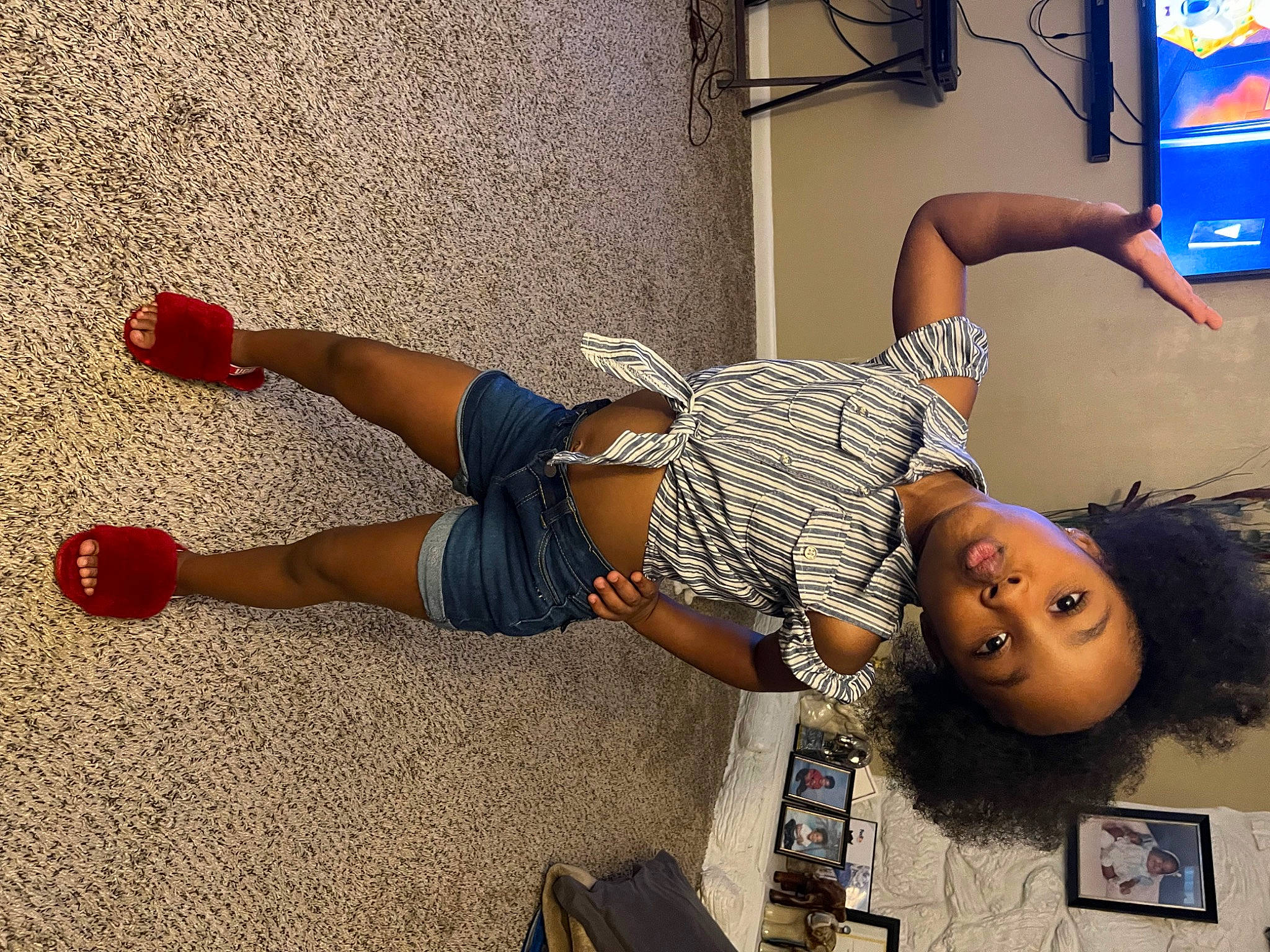 Zanaie is registered to the contest to win money with this photo: arm, child, elbow, fashion, floor, flooring, fun, happy, hat, human_leg, joint, knee, leg, leisure, person, room, sandal, shorts, thigh, waist