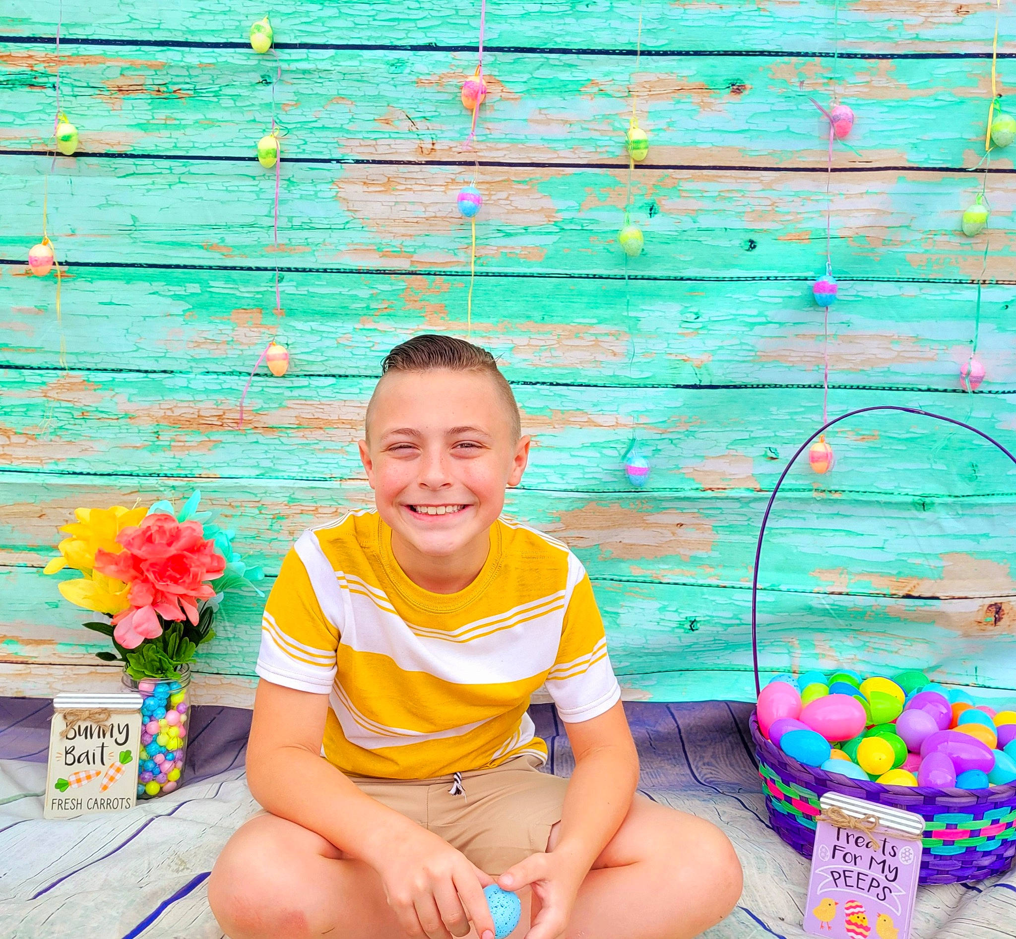 Maxton is registered to the contest to win money with this photo: child, electric_blue, flower, fun, grass, green, happy, human_leg, joy, leisure, pattern, people_in_nature, person, plant, recreation, shorts, sitting, smile, t_shirt, thigh