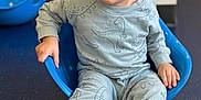 Avery joined the competition — help win amazing prizes! toddler, child, blue_chair, dinosaur_pajamas, sneakers, smiling, indoor, floor, playroom, cute, young_child, casual_clothing, seated, happy, person, portrait, head, face, short_hair, playtime
