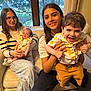 Avery joined the competition — help win amazing prizes! child, baby, toddler, family, couch, window, indoor, smile, happy, sibling, casual_clothing, glasses, yellow_flower_shirt, carpet, slippers, curtains, holding, seated, home, natural_light