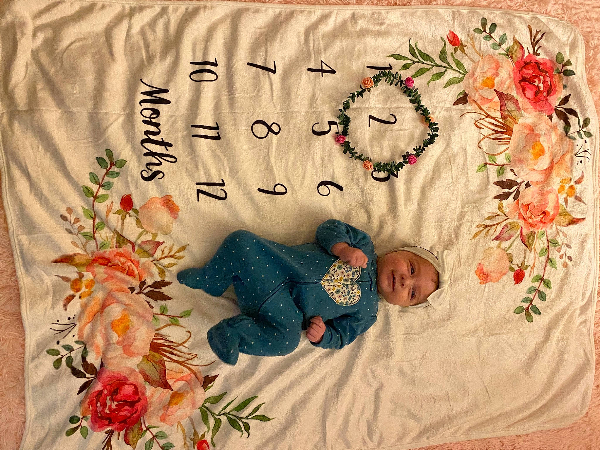 Avianna joined the competition — help win amazing prizes! baby, baby_toddler_clothing, bedding, child, comfort, flower, font, happy, headwear, linens, pattern, person, petal, plant, product, rectangle, room, rose, sleeve, textile