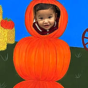 Luam is registered to the contest to win money with this photo: baby, child, pumpkin, pumpkin_costume, halloween, autumn, portrait, smiling, face, indoors, colorful, orange, blue_background, hand_painted, costume, infant, cute, seasonal, holiday, photography