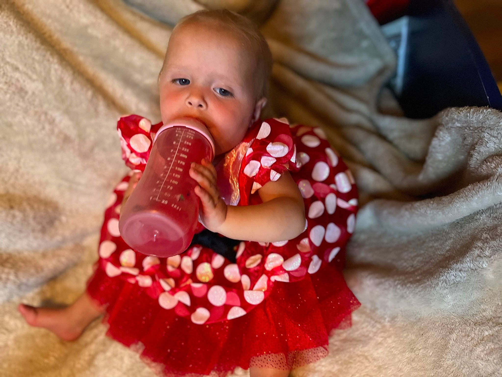 Emmilia is registered to the contest to win money with this photo: baby, baby_products, baby_sleeping, baby_toddler_clothing, cheek, child, comfort, dress, drinkware, finger, fun, hand, happy, head, human_body, nail, person, pink, skin, textile