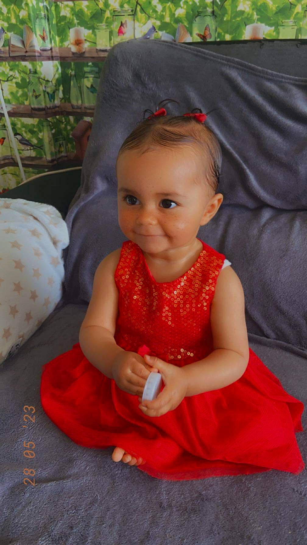 Nina participe au concours pour gagner de l'argent avec cette photo : baby, baby_toddler_clothing, cheek, child, chin, dress, event, eye, fun, hair, happy, head, iris, magenta, mouth, person, sitting, skin, sleeve, smile