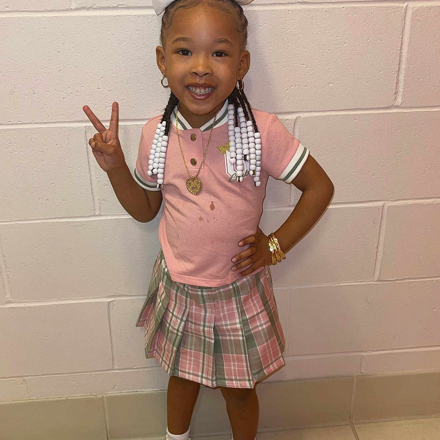 Malaysia is registered to the contest to win money with this photo: accessories, child, clothing, face, female, footwear, girl, hair, head, jewelry, miniskirt, necklace, person, photography, portrait, shoe, sitting, skirt, sleeve, standing