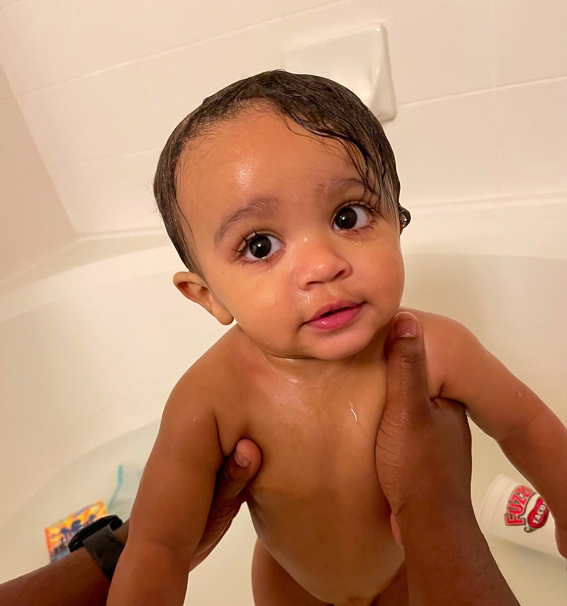 Blaize is registered to the contest to win money with this photo: arm, baby_bathing, bathroom, bathtub, cheek, ear, eyebrow, eyelash, face, forehead, hair, head, human_body, jaw, lip, mouth, neck, nose, person, plumbing_fixture