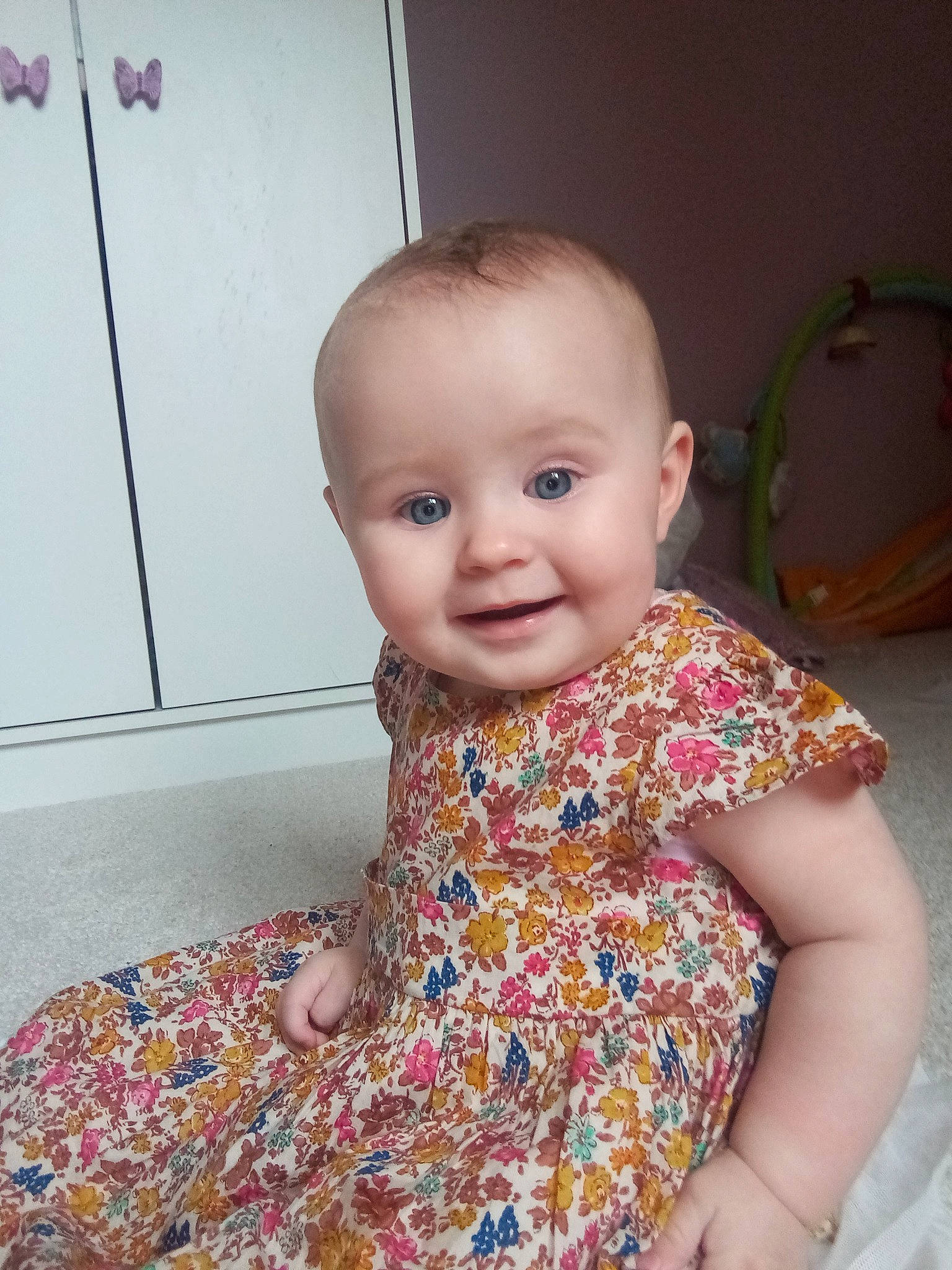 Amelia-rose is registered to the contest to win money with this photo: baby, baby_toddler_clothing, beauty, cheek, child, chin, clothing, dress, eye, flooring, happy, iris, joy, nose, outerwear, person, skin, sleeve, smile, standing