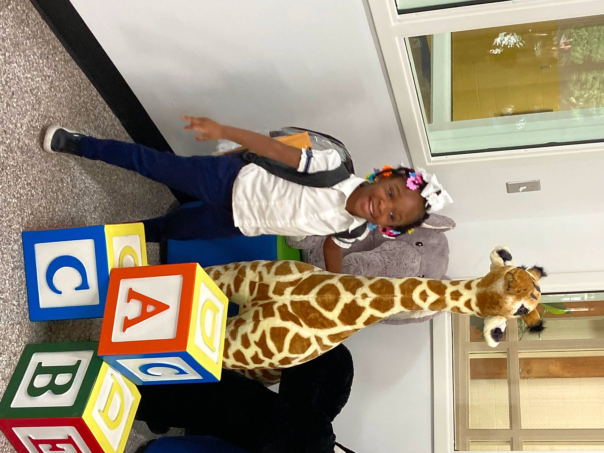 Ziyah joined the competition — help win amazing prizes! fawn, felidae, font, fun, giraffe, giraffidae, hat, joy, pattern, person, recreation, room, symbol, television