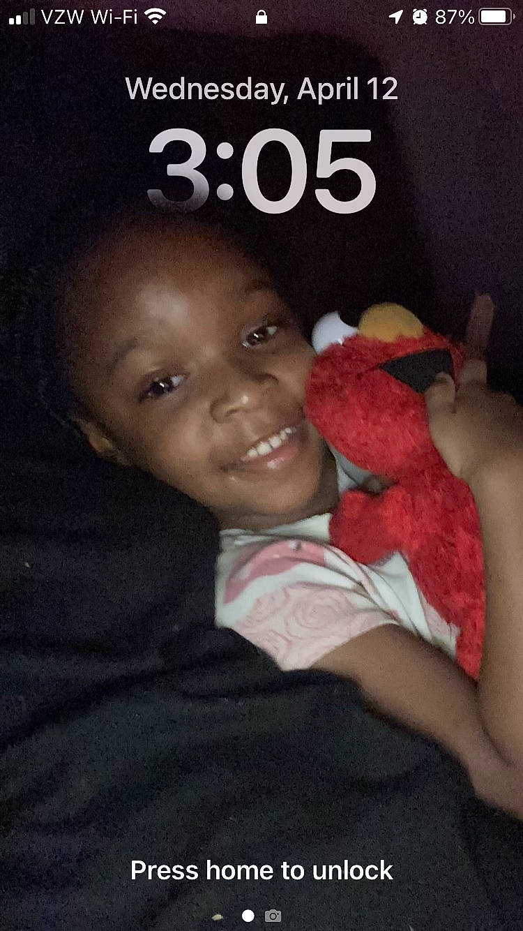 Ziyah is registered to the contest to win money with this photo: baby_toddler_clothing, book_cover, child, font, gesture, happy, joy, laugh, logo, person, photo_caption, plush, publication, room, sitting, smile, stuffed_toy, t_shirt, teddy_bear, thumb