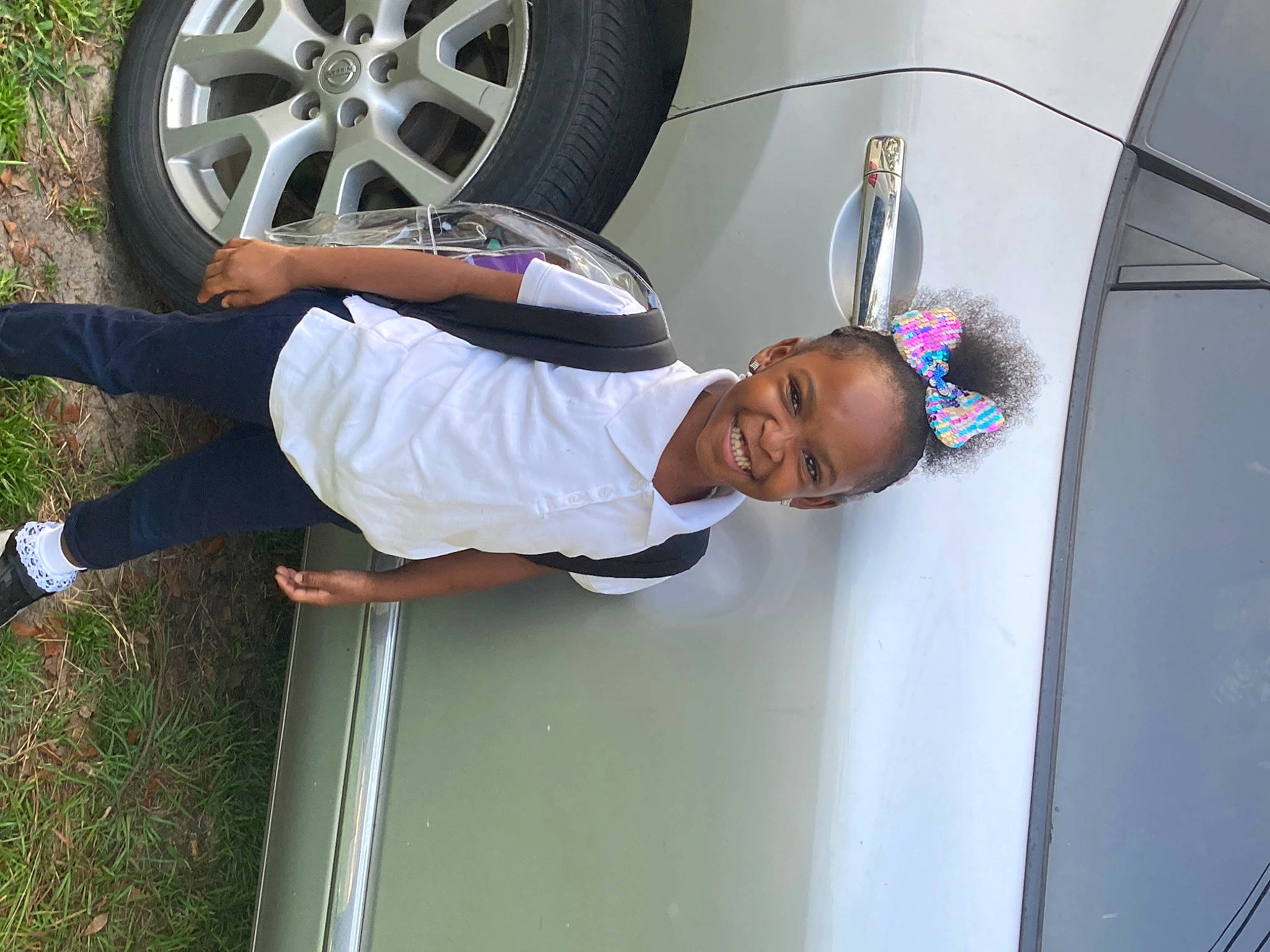 Ziyah is registered to the contest to win money with this photo: alloy_wheel, automotive_design, automotive_exterior, automotive_lighting, automotive_tire, automotive_wheel_system, car, clothing, fender, hood, hubcap, joy, land_vehicle, motor_vehicle, person, smile, sneakers, tire, tread, vehicle