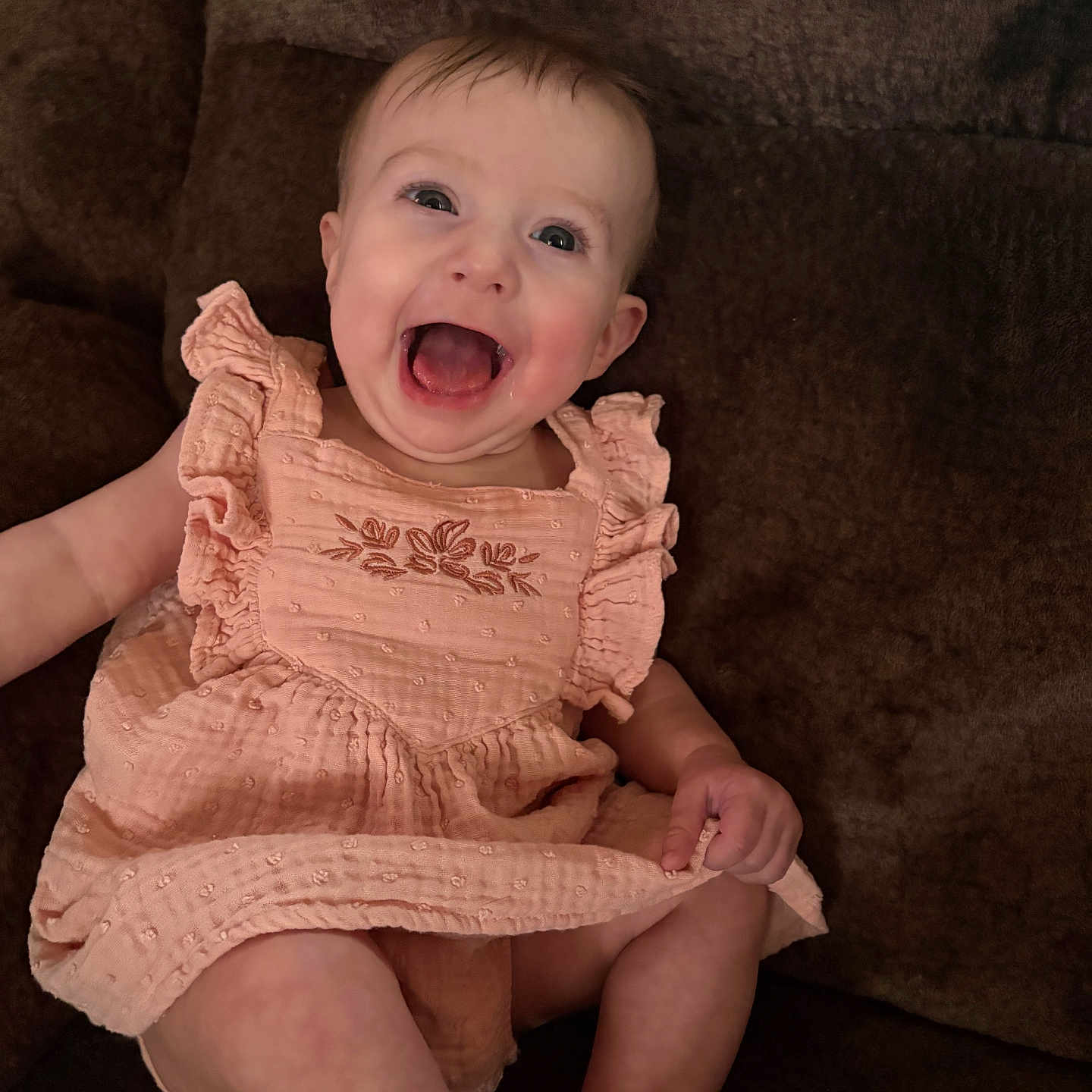 Evalynn joined the competition — help win amazing prizes! baby, child, smiling, happy, sitting, dress, peach, cute, infant, portrait, indoors, person, couch, furniture, skin, face, legs, hand, ruffles, joyful