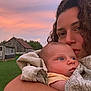 baby, woman, child, curly_hair, blanket, outdoor, sunset, barn, grass, sky, nature, portrait, holding, affection, expression, face, person, greenery, rural, love