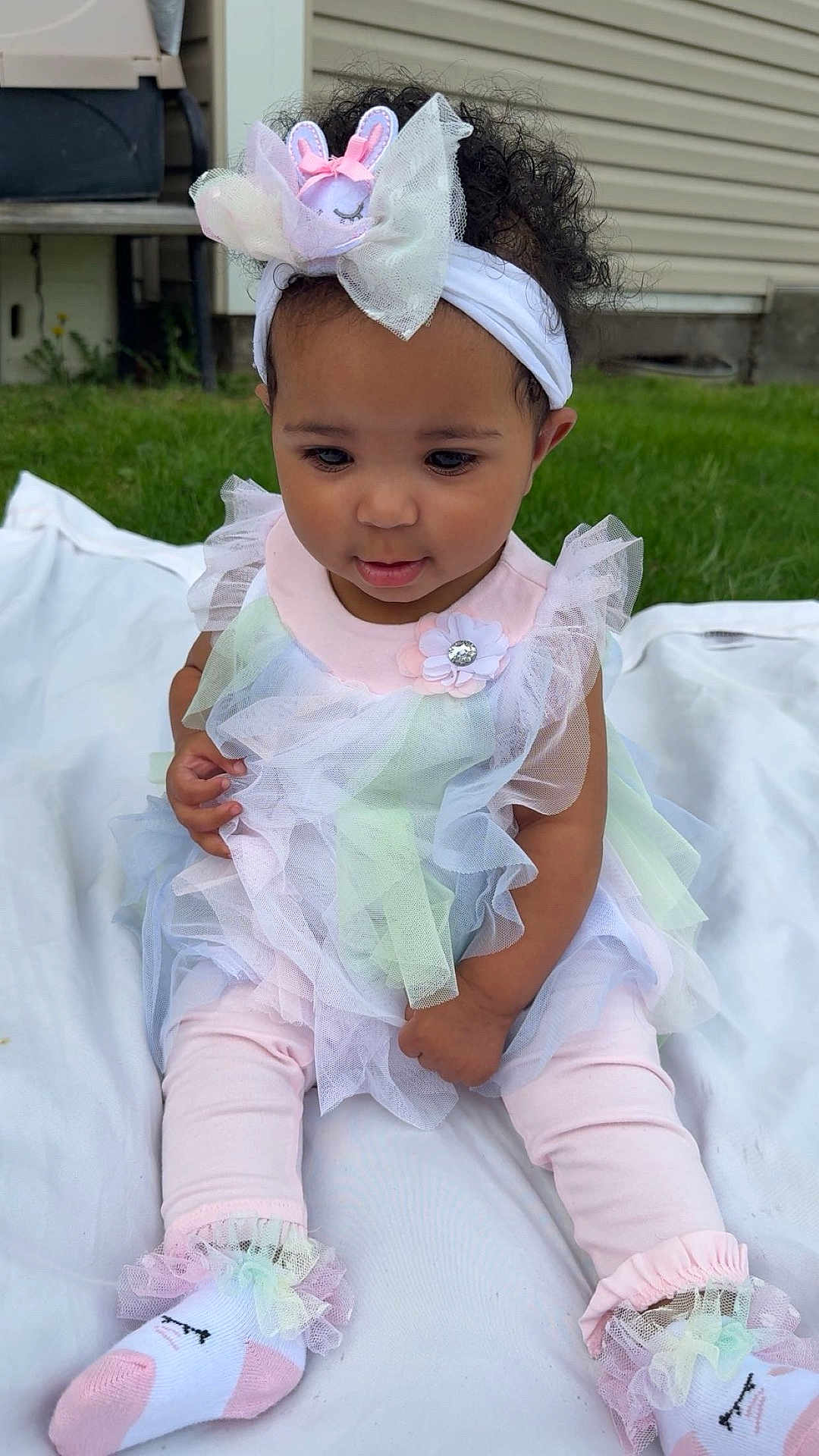 Lakyiah joined the competition — help win amazing prizes! toddler, child, baby, outdoor, grass, headband, bunny, ruffles, pastel_colors, pink, white_blanket, curly_hair, socks, cute, sitting, portrait, young_child, clothing, soft_toys, flower_accessory