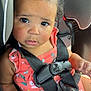 toddler, child, car_seat, seatbelt, safety, coral_dress, floral, curly_hair, hair_tie, big_eyes, expression, hand, buckled_up, car_interior, black_straps, cute, innocent, portrait, young_child, baby