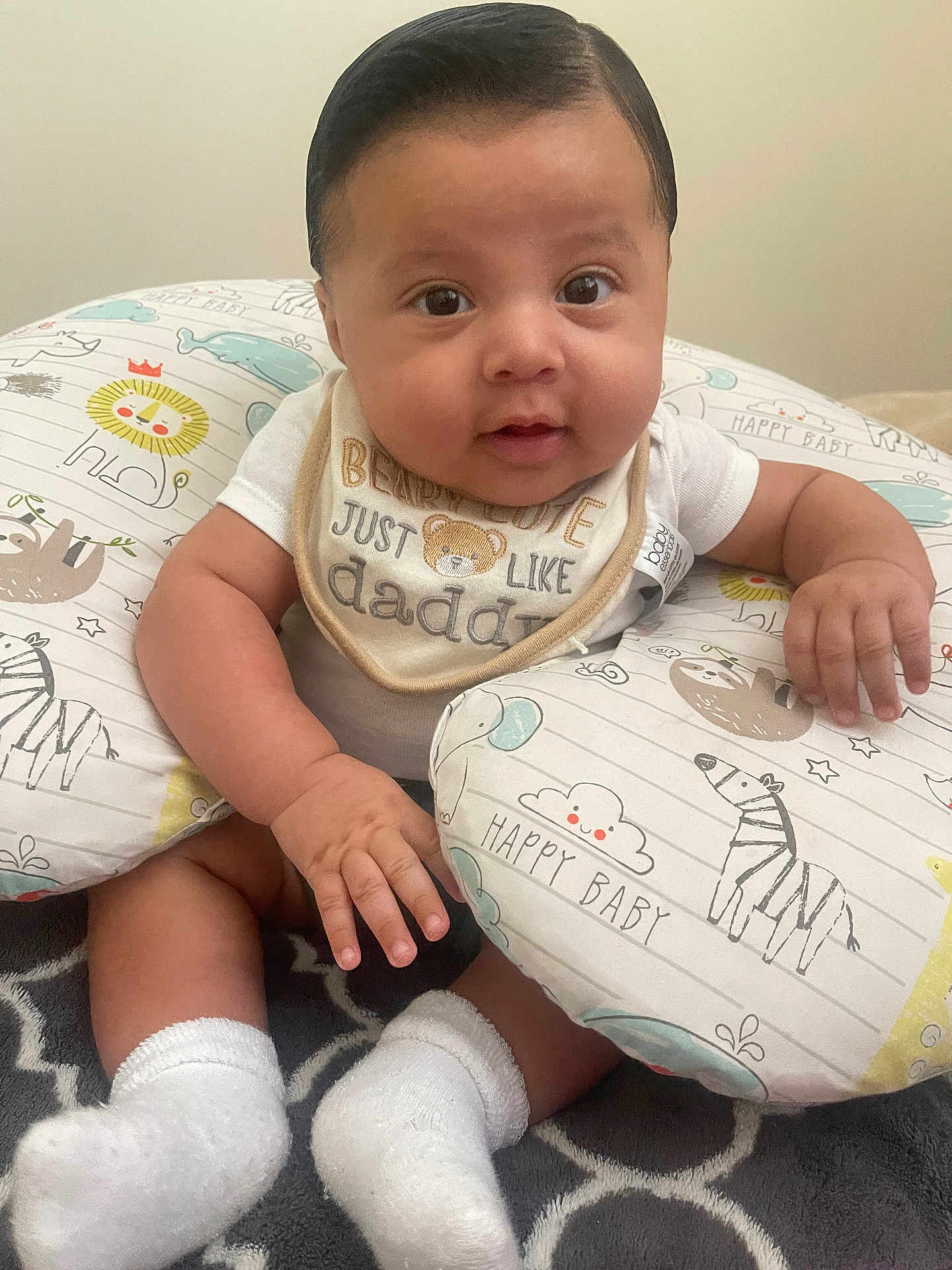 Sigberto joined the competition — help win amazing prizes! adorable, baby, bib, child, closeup, clothing, cute, eyes, face, hands, happy_baby, indoor, infant, patterned_pillow, pillow, sitting, skin, smiling, socks, soft_toys
