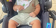Sigberto joined the competition — help win amazing prizes! baby, smiling, stroller, bib, shorts, striped_clothing, infant, cute, child, foot, hand, seat, outdoor, warning_label, fabric, toy, comfort, playful, happy, portrait