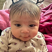 Valentina joined the competition — help win amazing prizes! baby, child, pigtails, hair, floral_clothing, pink_blanket, infant, cute, portrait, indoors, soft_texture, young_child, sitting, face, person, closeup, adorable, cozy, expression, skin