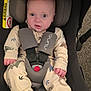 Seb joined the competition — help win amazing prizes! baby, car_seat, harness, infant, footwear, pajamas, dinosaur_pattern, face, eyes, clothing, child, sitting, sneakers, seatbelt, safety, indoor, person, cute, expression, hands