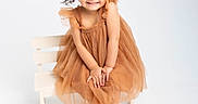Aria joined the competition — help win amazing prizes! child, girl, smile, dress, orange_dress, pigtails, hair_bows, bench, white_background, barefoot, cute, portrait, studio_photo, happy, young_child, posing, fashion, tulle, innocent, playful