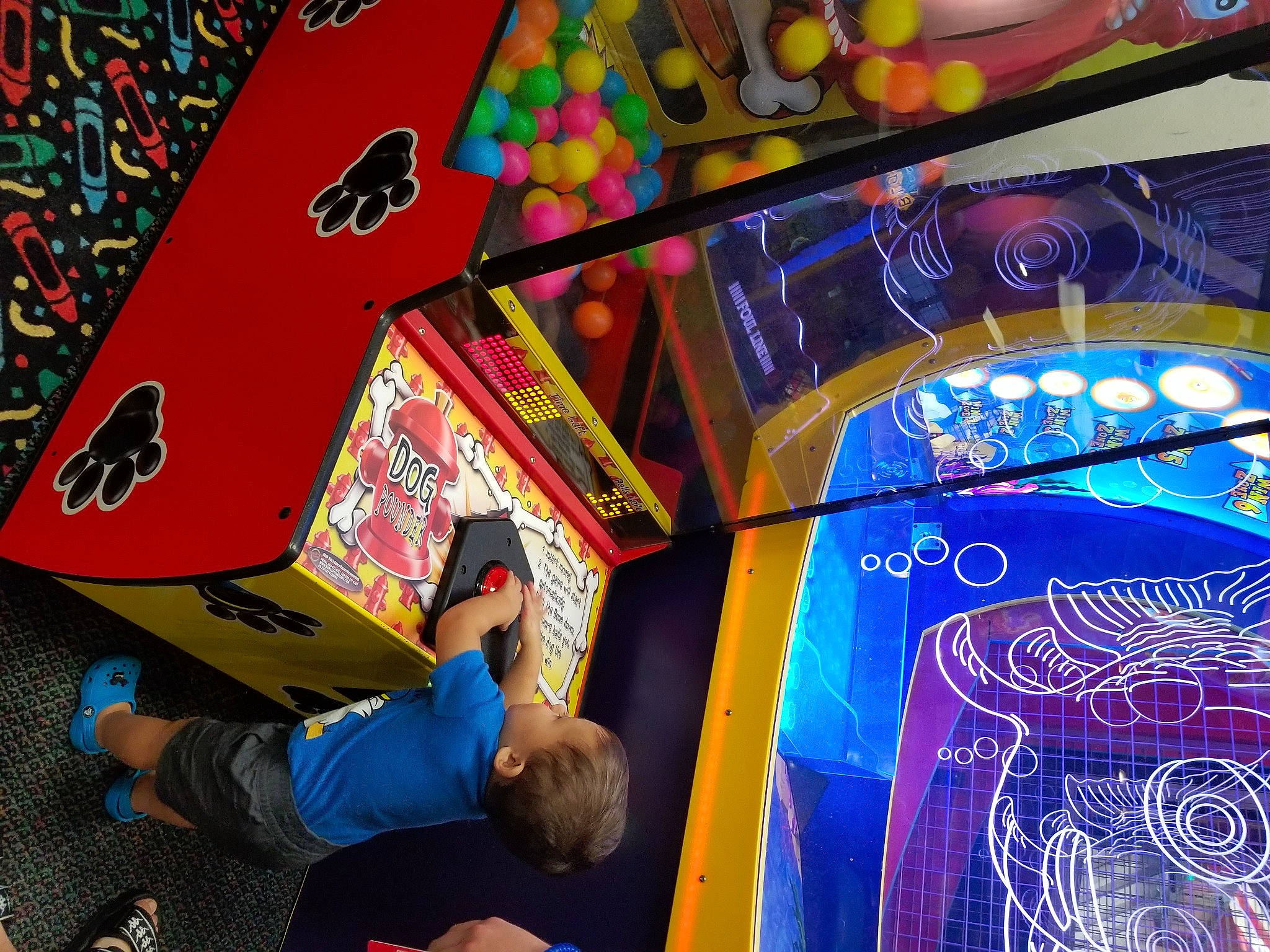 Isiah is registered to the contest to win money with this photo: arcade_game, art, artist, child, display_device, event, font, fun, games, glass, indoor_games_and_sports, leisure, person, play, recreation, room, space, t_shirt, toddler, visual_arts
