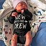 newborn, baby, infant, sleeping, onesie, hat, blanket, footprints, hospital, hospital_band, resting, cute, small, skin, hand, foot, lying_down, indoors, child, person