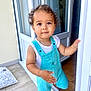 Andréa a rejoint le concours — aidez-le/la à gagner de superbes lots ! toddler, child, curly_hair, overalls, turquoise, white_shirt, doorway, indoors, outdoors, floor, window, curtain, hand, standing, looking_up, cute, portrait, baby, person, home