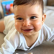 Lenzo participe au concours pour gagner de l'argent avec cette photo : baby, child, face, smile, happy, lying_down, blanket, soft_toys, indoors, infant, cute, portrait, cozy, young_child, eyelashes, clothing, head, skin, expression, background_blur