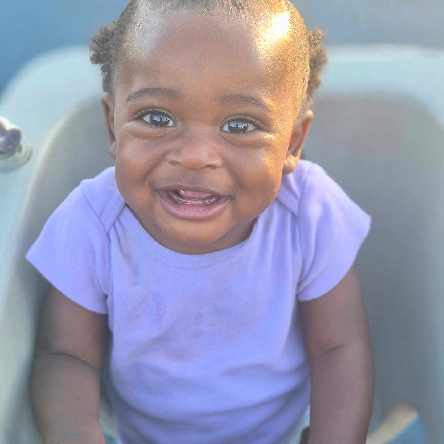 Kyzez Nicole Cox is registered to the contest to win money with this photo: toddler, child, smiling, happy, baby_seat, purple_shirt, curly_hair, outdoor, sunlight, portrait, cute, hands, person, face, young_child, infant, joy, photography, skin, expression