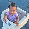 baby_swing, barefoot, child, commercial_swing, curly_hair, daylight, fun, happy, joy, little_tikes, outdoor, plastic_swing, play, playground, purple_shirt, reaching_hand, smiling, swing, toddler, young_child
