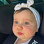 baby, child, car_seat, headband, clothing, white_top, face, eyes, hair, infant, indoors, seatbelt, cute, portrait, closeup, safety, car, window, sunlight, expression