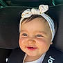 baby, child, smiling, headband, car_seat, seatbelt, indoors, portrait, infant, cute, happy, face, clothing, transportation, car_interior, safety, closeup, person, young_child, vehicle