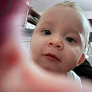 Zmarii is registered to the contest to win money with this photo: baby, infant, close_up, portrait, face, eyes, nose, mouth, cheek, skin, finger_blur, hand, curious, cute, indoor, ceiling, shelf, furniture, clothing, photography