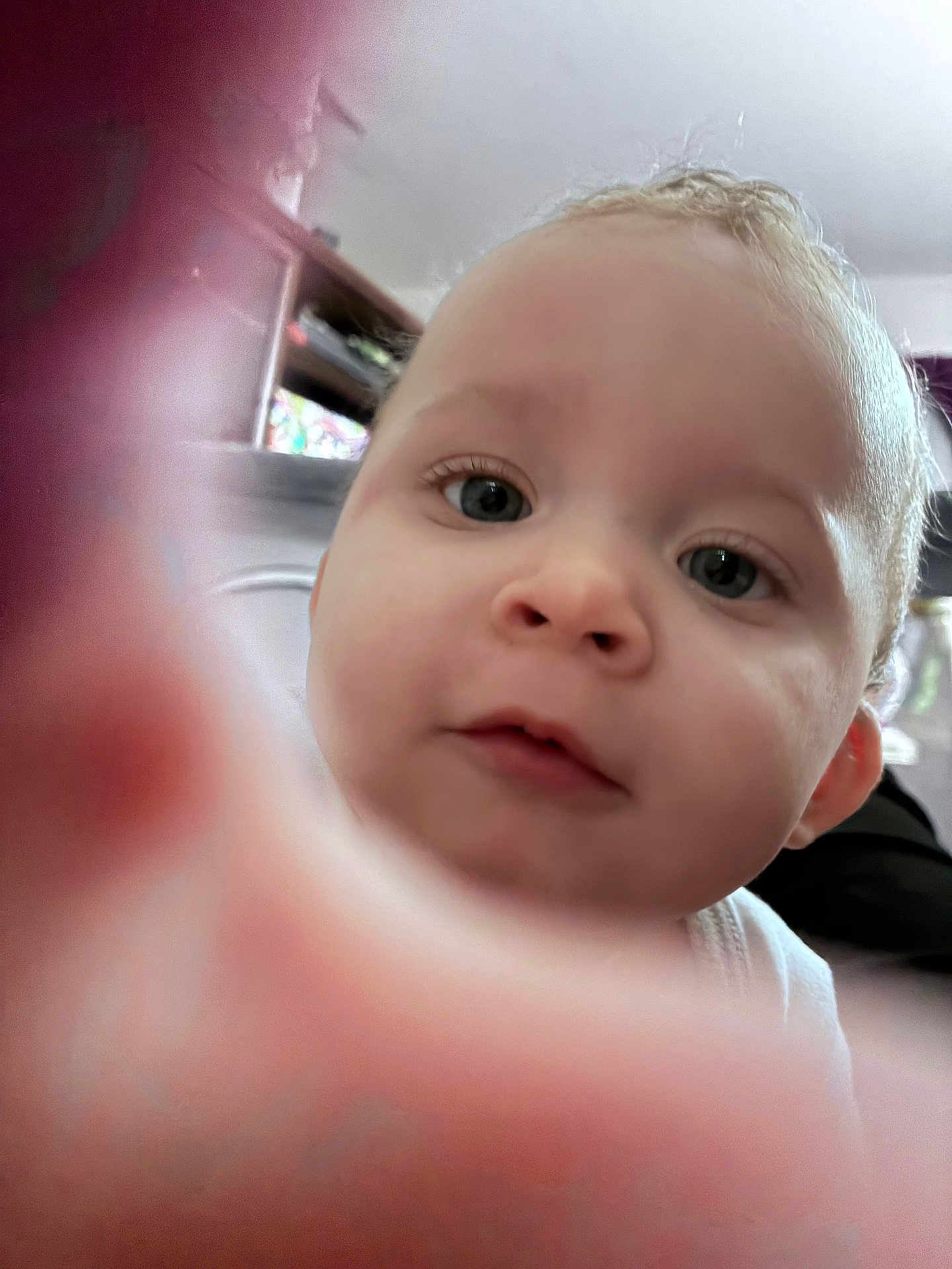 Zmarii is registered to the contest to win money with this photo: baby, infant, close_up, portrait, face, eyes, nose, mouth, cheek, skin, finger_blur, hand, curious, cute, indoor, ceiling, shelf, furniture, clothing, photography
