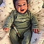 Sasha participe au concours pour gagner de l'argent avec cette photo : baby, infant, smile, happy, green_clothing, onesie, baby_nest, cushion, soft_fabric, indoor, cute, child, portrait, person, baby_accessory, toy, comfort, cozy, limited_edition, playful