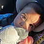 baby, car_seat, plush_toy, child, close_up, sunlight, shadow, seatbelt, cute, soft_toy, infant, portrait, hand, seat, headrest, expression, indoors, sitting, young_child, face