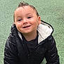 toddler, child, smiling, black_jacket, crawling, playground, green_surface, grass, outdoor, happy, face, person, cute, young_child, jacket, play, fun, daylight, baby, park