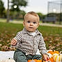 Damian joined the competition — help win amazing prizes! baby, child, pumpkin, blanket, plaid_shirt, green_pants, socks, outdoor, park, grass, autumn, fall_leaves, face, blue_eyes, cute, sitting, nature, seasonal, holiday, harvest
