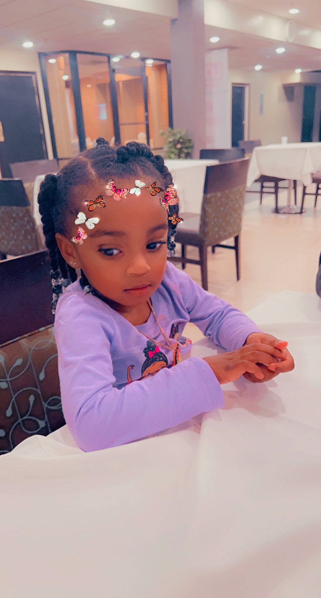 Ariana is registered to the contest to win money with this photo: audio_equipment, chair, child, event, eyelash, fashion_accessory, fashion_design, flooring, formal_wear, fun, hair_accessory, happy, jewellery, magenta, person, purple, room, sitting, table, toddler