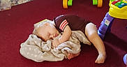 Robert is registered to the contest to win money with this photo: blanket, carpet, child, clothing, colorful, comfort, cuddle, floor, foot, hand, indoor, nap, peaceful, person, playroom, relaxation, sleeping, soft, toddler, toy